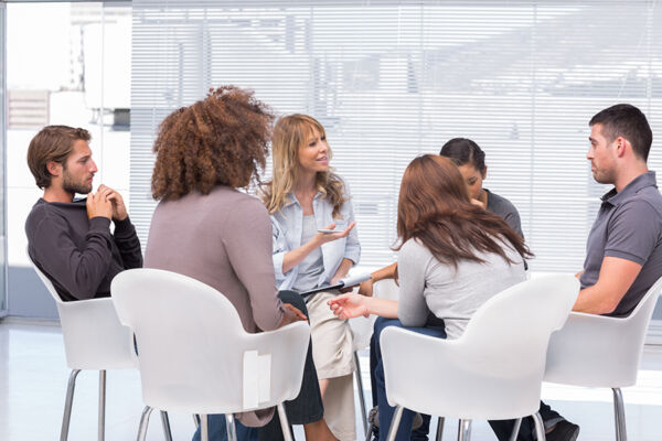 A circle of participants engaged in group therapy, highlighting the effectiveness of Multiplan mental health program in promoting behavioral health