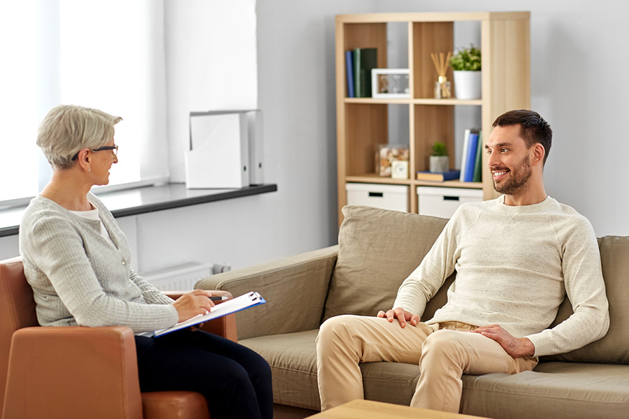 A comfortable therapy room with soft lighting and seating during individual therapy session for dependent personality disorder