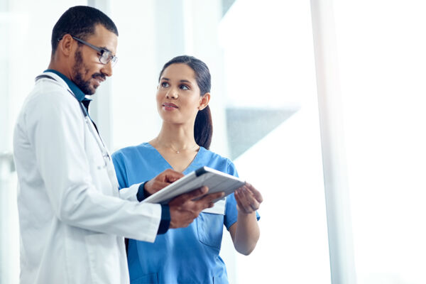 A doctor and nurse discussing patient care, illustrating the process of inpatient mental health treatment and support