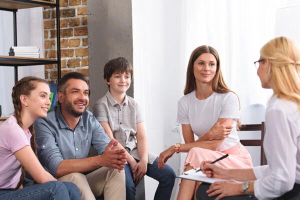 A happy family participating in a therapy session celebrating their journey of Phoenix addiction recovery and healing