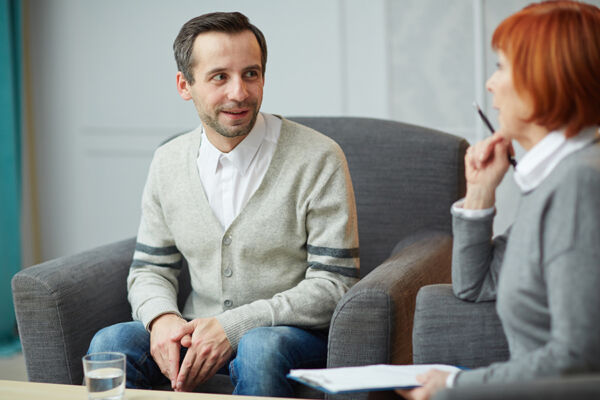 Man speaking to therapist in individual therapy session covered by multiplan mental health insurance coverage