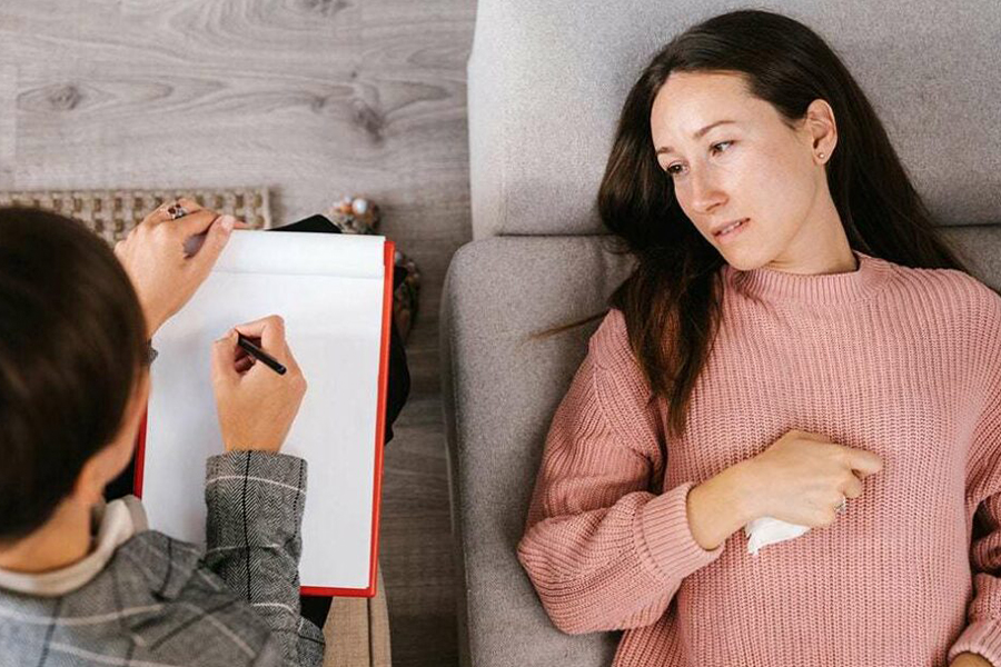 A therapist engaging in Cognitive Behavioral Therapy (CBT) with a patient during one of the therapeutic day treatment programs.