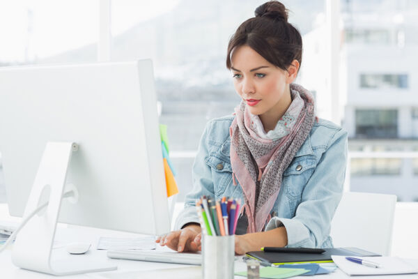 A young woman maintaining her office work while benefiting from Gilsbar mental health coverage in an outpatient treatment setting