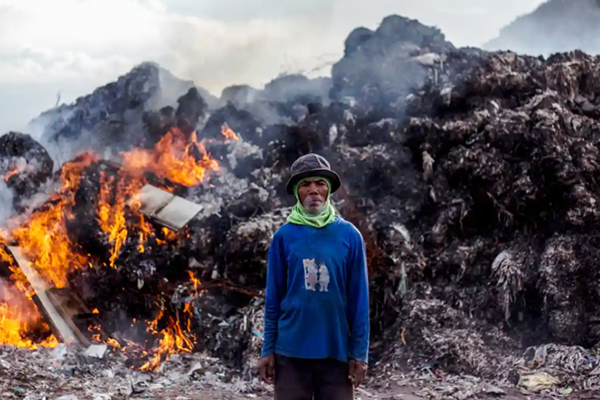 Adult male surrounded by pollution representing the environmental factors that affect mental health