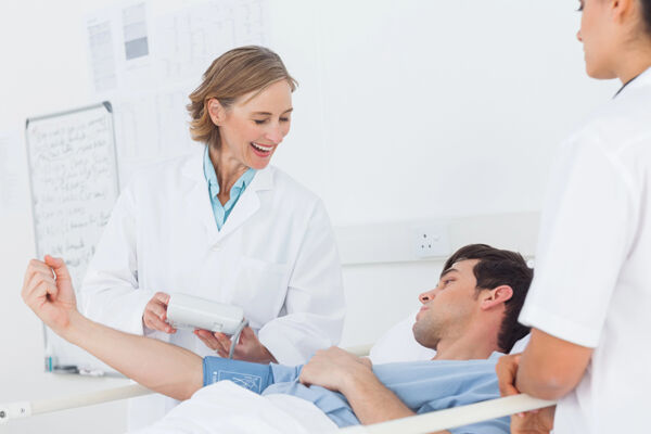 Medical staff assisting a patient in a rehab that accepts in-network TRICARE for addiction, highlighting a caring and professional environment