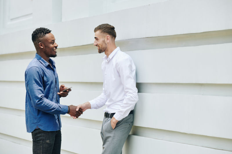 Two men shaking hands, symbolizing hope with addiction intervention services in Phoenix AZ