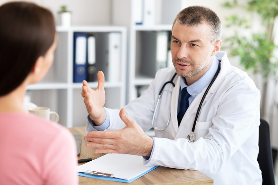 Doctor explaining how long does drug detox take to a patient during a consultation in a medical office