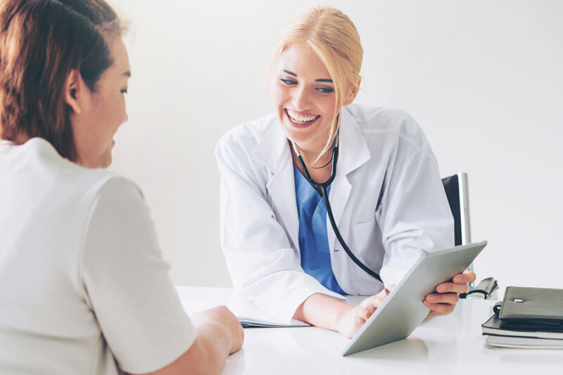 Doctor smiling while discussing ketamine treatment options with a patient, highlighting an alternative approach for mental health care