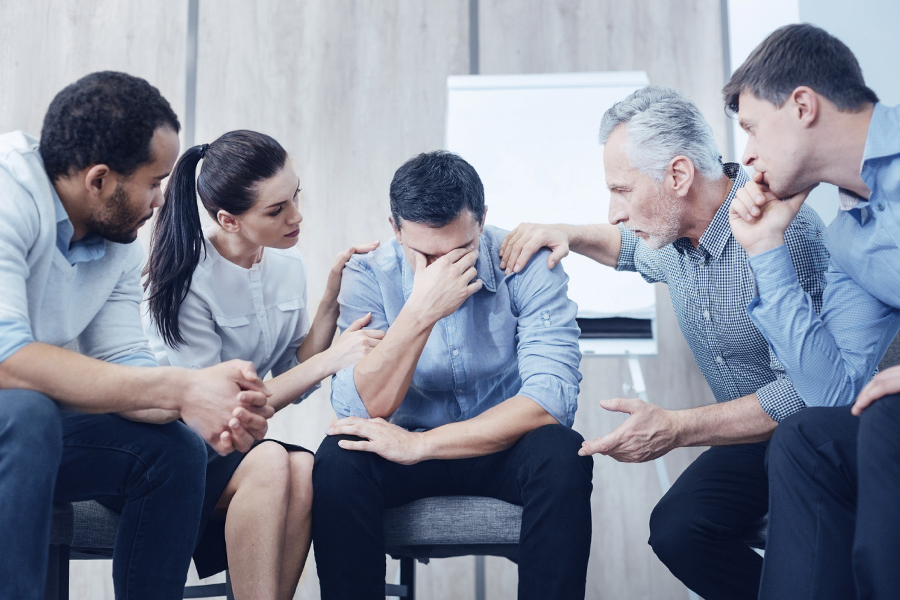 Family and friends providing comfort and guidance to a distressed individual, emphasizing how to break cocaine addiction