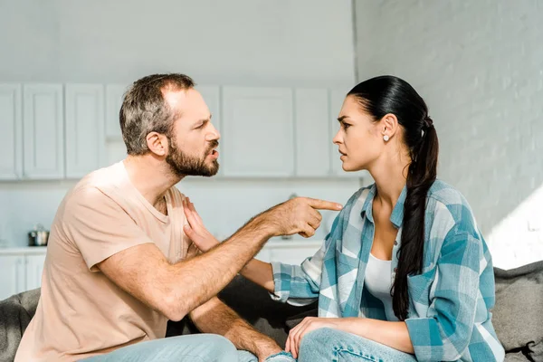 Man expressing anger towards his wife during alcohol addiction withdrawal, displaying mood swings and emotional distress