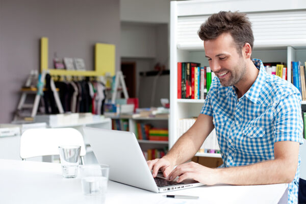 Man working on his laptop, showcasing the benefits of outpatient mental health treatment