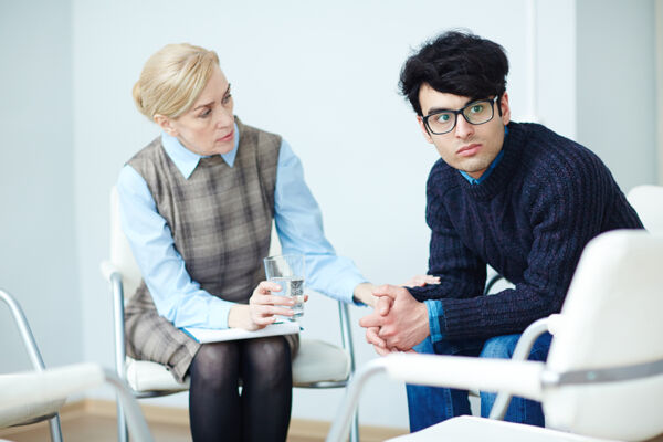 Patient in therapy for bipolar and addiction treatment, looking away in contemplation