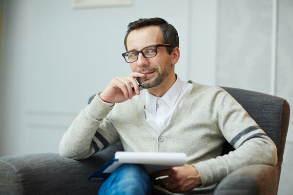 Psychiatrist sitting with a clipboard in hand, providing mental health services near Gilbert, AZ