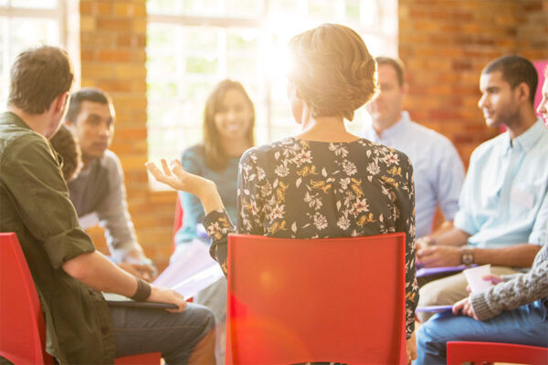 Group therapy session addressing mental health concerns with engaging discussion 