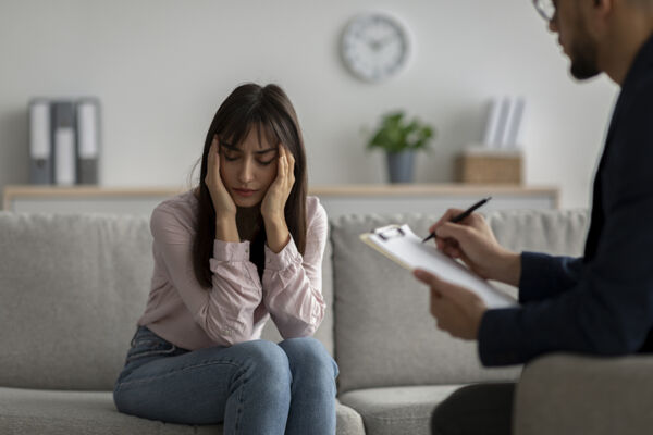 Young female experiencing a nervous breakdown during individual therapy session covered by Medica mental health services