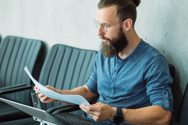 Young man reviewing his insurance documents for Medica mental health treatment options