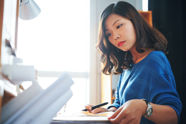 Young woman reviewing her mental health insurance policy for coverage